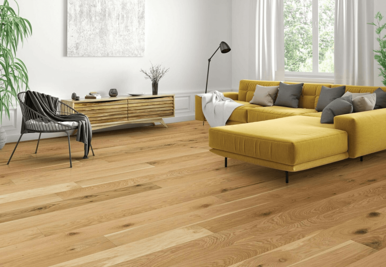 A modern living room with light natural hardwood flooring, a yellow sectional sofa, and minimalist decor.