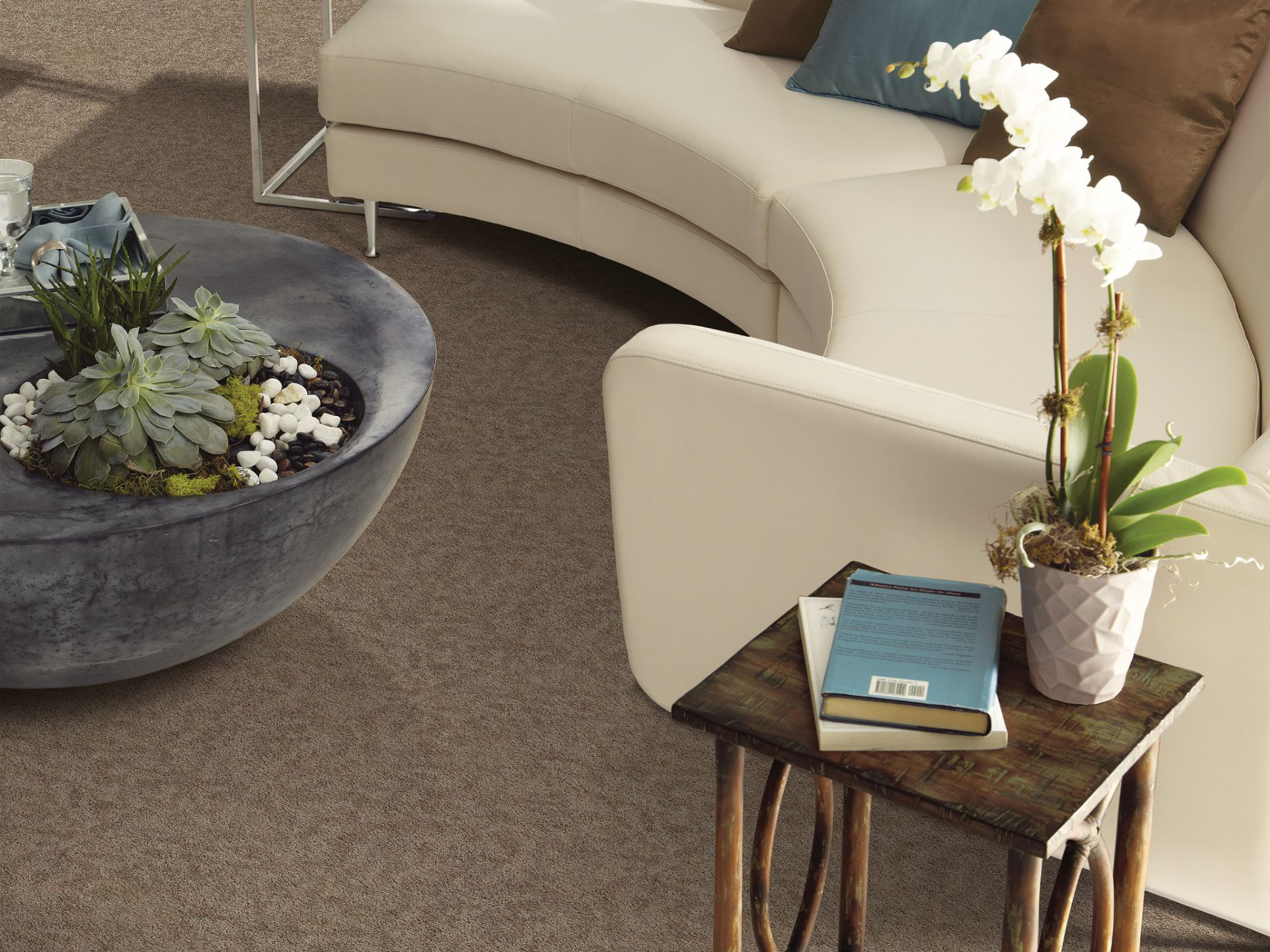 Office lobby with carpet flooring, modern sofa seating, and decor accents creating a warm, professional waiting area.