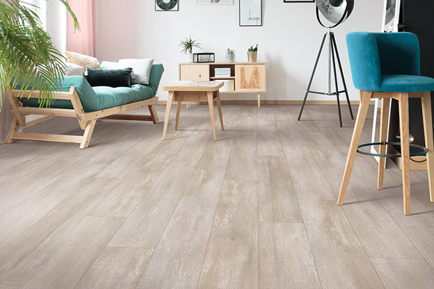 Tampa Flooring | Fresh Flooring Ideas for a Spring Home Refresh Modern living room featuring light-colored wide plank wood flooring and teal furniture.
